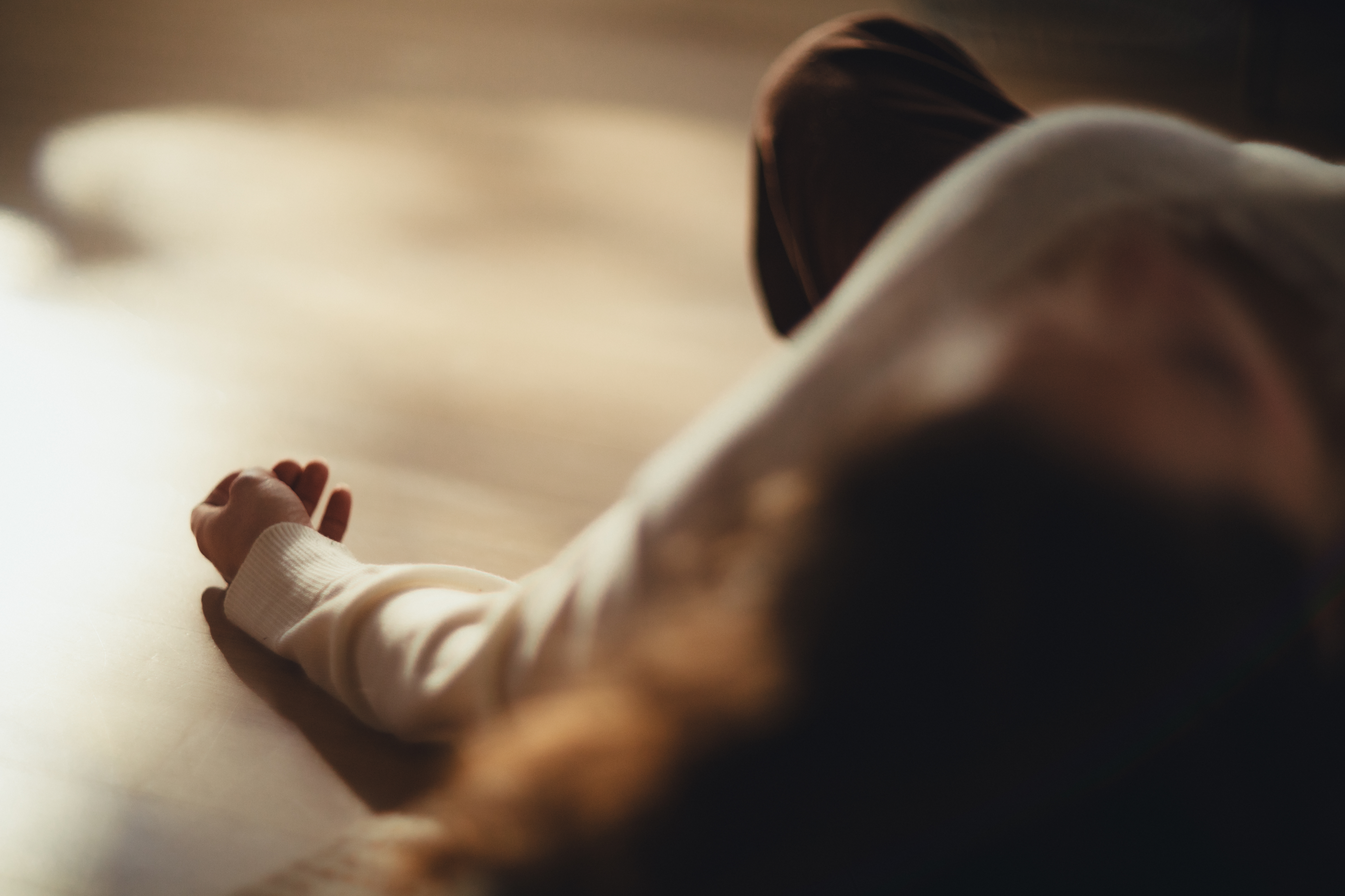 Gentle mudra hand position in warm soft light representing meditative practice at Beautiful Yoga